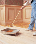 Person applying Clear SealCoat Universal Sanding Sealer For Interior Wood And Floors, Fast Drying, Sandable In Minutes on hardwood floor