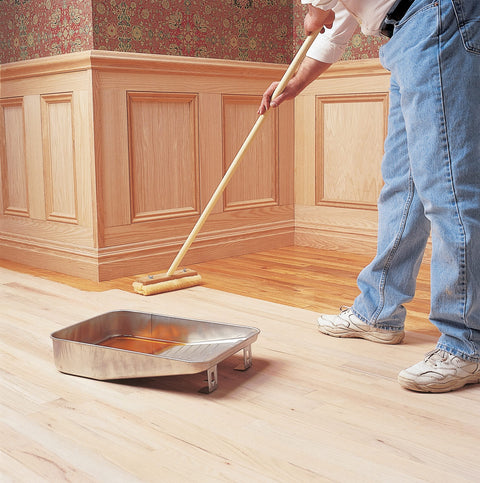Person applying Clear SealCoat Universal Sanding Sealer For Interior Wood And Floors, Fast Drying, Sandable In Minutes on hardwood floor