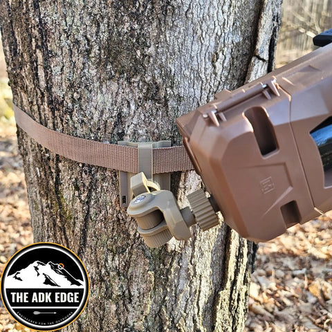 Universal Trail Camera Mount With Standard Camera Thread And 360 Degree Leveling Plus 180 Degree Tilt No Sweat Strap Rig for tough hunts attached to a tree.