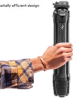 Person holding compact folded Carbon Fiber Travel Tripod With Pro Level Stability, Fast Setup And Takedown, Ergonomic Ball Head.