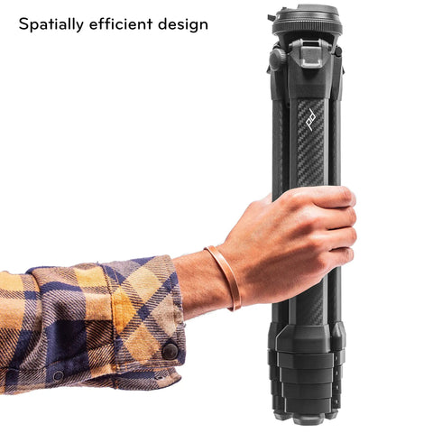 Person holding compact folded Carbon Fiber Travel Tripod With Pro Level Stability, Fast Setup And Takedown, Ergonomic Ball Head.