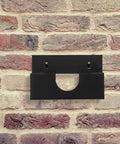 Black iron Heavy Duty Angle Grinder Holder Wall Mount Organizer installed on brick wall for tool storage.