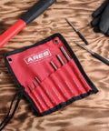 Nine Piece Roll Pin Punch Set Pro Grade With Durable Heat Treated Drop Forged Steel Pins And Nylon Pouch on a wooden table