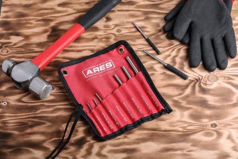 Nine Piece Roll Pin Punch Set Pro Grade With Durable Heat Treated Drop Forged Steel Pins And Nylon Pouch on a wooden table