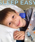 Blue Bedwetting Alarm With Loud Sound And Strong Vibration For Boys And Girls Enuresis Alarm With Six Tones And Vibration Alerts Go To Compact Sensor Unit That Uses 2 AAA Batteries And Is Easy To Clean on a sleeping child