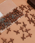 Hella Sturdy Wooden Cross Charms Bulk Pack Of Sixty Pocket Size Beads With Pre Drilled Hole For DIY Necklace Projects And Religious Craft Supplies Top Shelf Quality in a clear box.