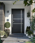 Modern front entrance with black door featuring a long vertical handle, surrounded by greenery and modern design elements.