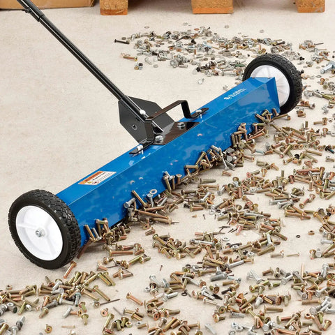 Heavy Duty Magnetic Floor Sweeper With Thirty Six Inch Wide Cleaning Path And Smooth As Butter Rubber Wheels For No Sweat Cleanup On Concrete Asphalt Grass Or Gravel Featuring Dead Simple Dump Lever And Easy Fold Handle In Striking Blue And Black, cleaning nails and screws off the ground.