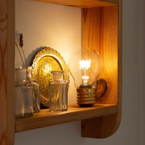 Cordless USB Rechargeable LED Light Bulb Lamp With Vintage Edison Glow on wooden shelf, soft warm ambient lighting