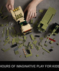 Hands assembling Military Vehicle Building Kit Dual M142 HIMARS and Dana M2 Howitzer Army Truck on grey surface
