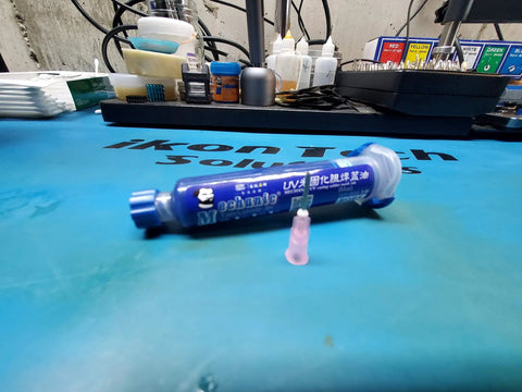 Blue UV Solder Paste Flux Solder Mask Kit For PCB Repairs with needle tip syringe on workbench for SMD BGA protection.
