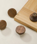 Modern Warm Walnut Wood Cabinet Knobs And Single Hole Drawer Pulls For Dressers Bedroom Furniture Upgrade Fresh Vibe Solid Natural Finish Essential Hardware - Round knobs on light surface.