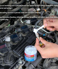 Applying dielectric grease to car spark plug with Dielectric Grease For Electrical Connectors And Battery Terminals, Spark Plugs, And O Ring Seals, Waterproof Silicone Lube For Automotive Use, 4 Oz One Pack, Heavy Duty Insulation And Moisture Protection tub visible in engine bay