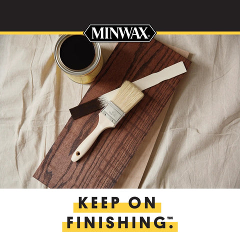 Quick Dry Oil Based Polyurethane Spray For Interior Woodwork Clear Semi Gloss Top Coat next to paint brush and wood piece.