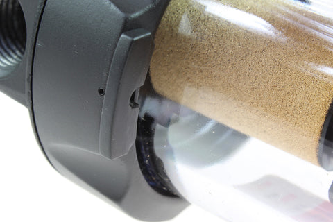 Close-up of die-cast aluminum and polycarbonate body on a Rugged Heavy Duty Pneumatic Filter For 1 Inch Pipe Size That Keeps Water And Particles Out Of Your Compressed Air Built To Last Die Cast Aluminum And Polycarbonate Body 40 Micron Bronze Element Max 150 PSI Up To 120 Degrees Fahrenheit, showcasing the 40 micron bronze element inside the transparent housing.