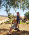 Children playing on a swing made from Heavy Duty Hemp Rope 1 Inch Thick and 100 Feet Long for outdoor projects under a tree.