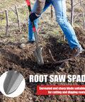 Person using Drain Spade Root Saw Shovel With Fiberglass Handle for digging and trenching in a garden, focus on steel head.