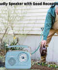 Grab N Go Portable AM FM Shortwave Radio Bluetooth Speaker with gardener watering plants in yard.