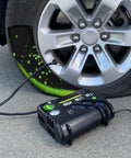 Flat Tire Emergency Repair Kit with Five Point Eight Four Ounce Sealant and Digital Tire Inflator Pump for Cars and Highway Vehicles displayed in use on a tire