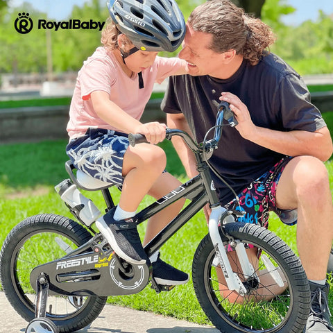 Parent helping child ride bike with Universal One Piece Crankarm Set For 20 Inch Bikes Black Durable Crank Kit visible