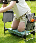 Person using 2 In 1 Garden Kneeler And Seat With Wide EVA Foam Kneeling Pad Detachable Tool Pouch Upgraded Folding Gardening Work Bench outdoors