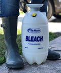 Person standing next to a 1.5 Gallon Bleach Sprayer Handheld Chemical Sprayer With Viton Seals on a concrete path.