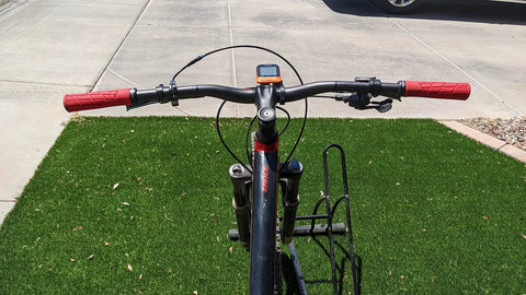 Front view of a bike with Carbon Fiber 760mm Mountain Bike Handlebars 31.8 Clamp Riser Bar Glossy 3K Black Red Lightweight Non Slip Shockproof.