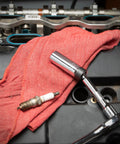 3/8 Inch Drive 6 Point Magnetic Swivel Spark Plug Socket 5/8 Inch By 6 Inch tool on engine with red cloth and spark plug