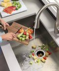 Continuous Feed Garbage Disposal 1/2 HP with 2600+ RPM grinding vegetables in kitchen sink, easy install, green finish visible.