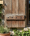 Rustic wooden shutter with Colonial Era Solid Cast Iron Decorative Nailhead Studs for doors, creating a vintage look