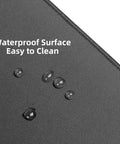 Beastly Gaming Mouse Pad 36 By 17 Inches Waterproof Non Slip Desk Keyboard Mat With Soft Rubber Surface And Lock Edge Easy Clean XL Extended Mouse Pad For Smooth Accurate Tracking And Comfort, close-up of waterproof surface with water droplets.