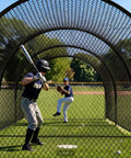 Two players practice in 33 Ft Baseball Batting Cage With Frame And Net For Backyard Or Field Practice Hitting And Pitching, Durable Polyester Netting