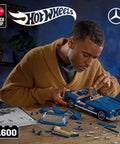Man assembling Hot Wheels Premium Building Set 1 To 12 Mercedes Benz 300 SL Dope Model Kit With 1600 Pieces Realistic Details
