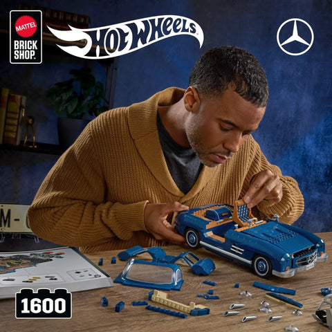 Man assembling Hot Wheels Premium Building Set 1 To 12 Mercedes Benz 300 SL Dope Model Kit With 1600 Pieces Realistic Details