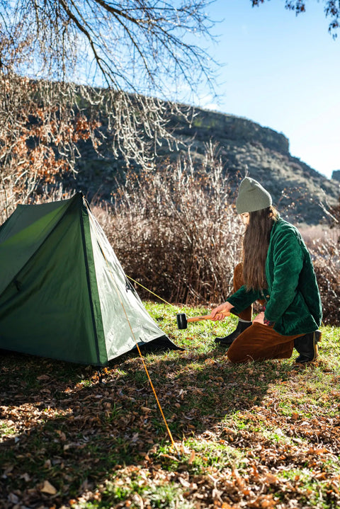 Person setting up Forest Scout Backpack Tent for Quick Camp Setup Lightweight Frame Shelter With 1000mm PU Coated Polyester