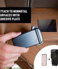 Attaching a black Waterproof Magnetic Key Box For Spare Keys with adhesive plate to a wooden surface, showing the secure key holder.