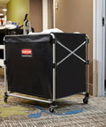 Collapsible X Cart with Wheels 8 Bushel Steel Laundry Cart Heavy Duty Black Utility Cart in hotel hallway