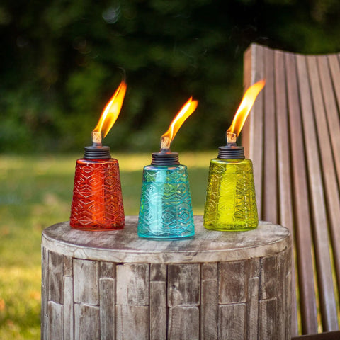 Set Of 3 Molded Glass Tabletop Torches In Rio Red, Key Lime Green, And Ocean Blue For Outdoor Lawn, Patio And Garden Lighting on table