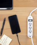 Four Outlet Power Strip With 1.5 Foot Extension Cord Twist To Lock Safety Covers Built In Circuit Breaker UL Listed White on desk