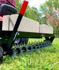 Tow Behind Spike Aerator With Transport Wheels, 40-Inch Lawn Aerator, 11 Tine Stars With 12 Spike Tips in a garden setting