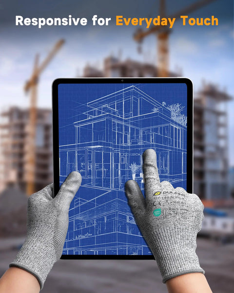 Hands wearing ANSI A3 Cut Resistant Work Gloves With Grippy PU Coating For Men And Women, touching tablet at construction site