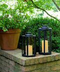 Outdoor Solar Powered Lantern With Flameless Candle 18 Inch Black Metal And Glass Waterproof Hanging Tapered Candle Lamp for garden decor.