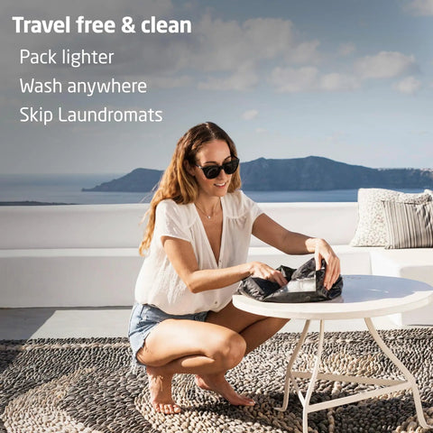 Woman using a Lightweight Portable Travel Laundry Bag With Patented Washboard Interior for quick cleaning while traveling.
