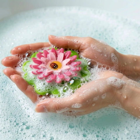 Flower Power Bathtub Drain Stopper With Chain Pink Green Universal 4 1 4 Inch Bath Plug in hands filled with bubbles.