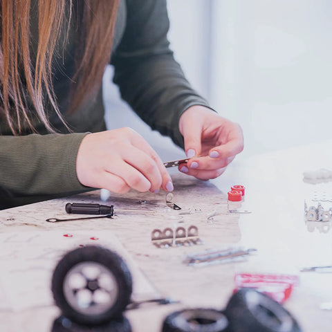 Hands assembling the Beast Mode Erector Set Metal Model Kit For Adults Teens And Advanced Kids Build Cars Planes And Excavators