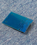 Mifare RC522 NFC Reader Module Kit With S50 White Card And Key Ring on blue surface, back view showing circuits and pins