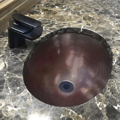 Waterfall Lav Faucet With Single Lever, Oil Rubbed Bronze Finish, Solid Brass Construction, mounted beside a marble sink