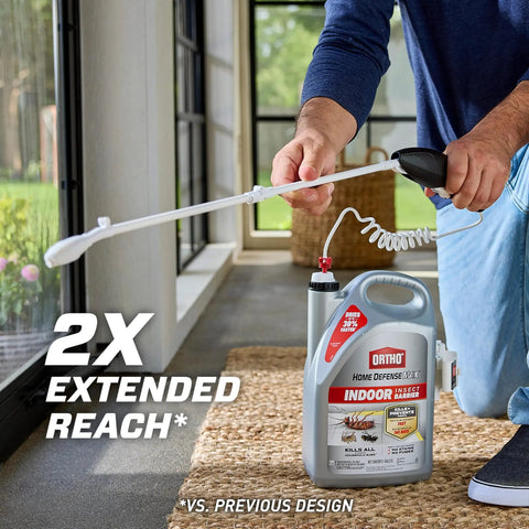 Indoor Insect Killer Spray With Wand Builds A Tough Shield Against Roaches, Ants, Spiders, Ticks And Fleas Ready To Use 1 Gallon with extended reach wand in use.