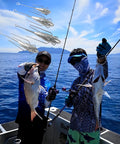 Two anglers holding fish with 3 Piece Sputnik Lead Fishing Sinkers Set 1oz For Surf Casting Saltwater Ocean Beach in the sky.