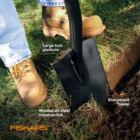 46 Inch Steel Flat Spade With Ergonomic D-Handle For Lawn Edging And Tough Digging shown cutting soil with sharp blade, close-up.